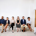 Shot of a group of businesspeople seated in line while waiting to be interviewed.